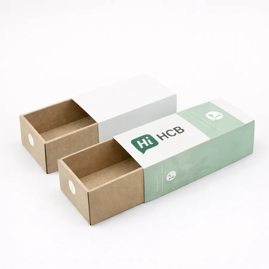 Two sliding drawer boxes made of kraft paper with white and mint green branded sleeves- class=